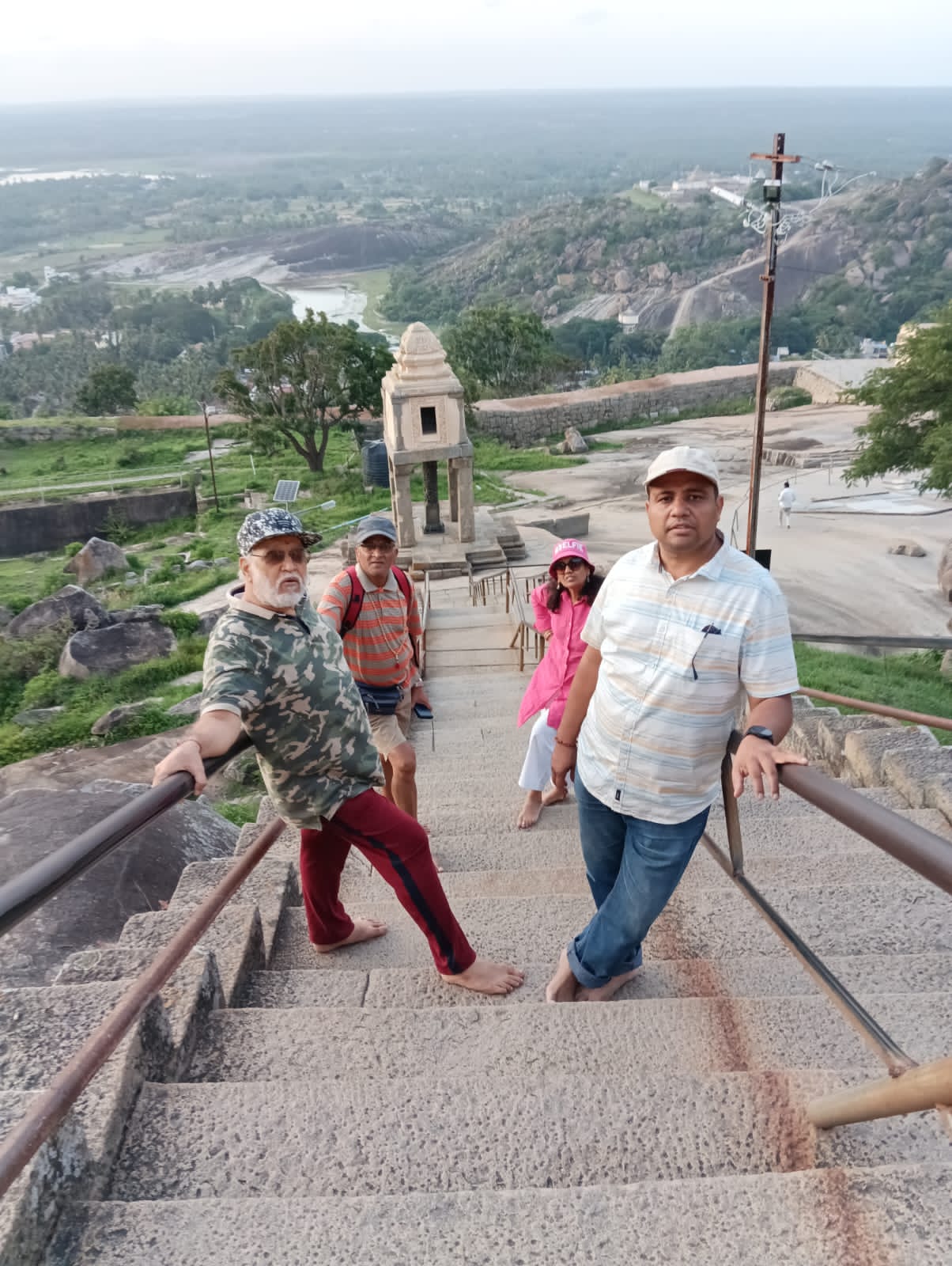 Vipin Bhardwaj with fellow guides on the hill-top steps of a temple in Karnataka