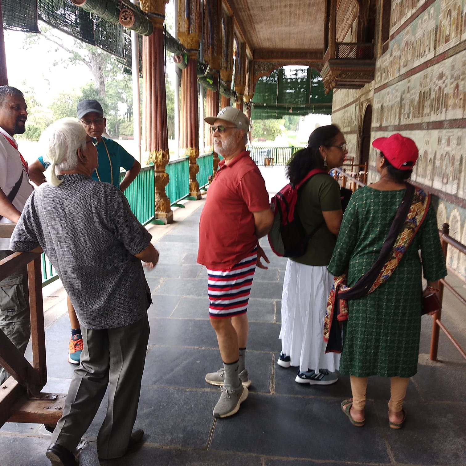 Vipin Bhardwaj guiding a group along the painted corridor of the Mysore Palace