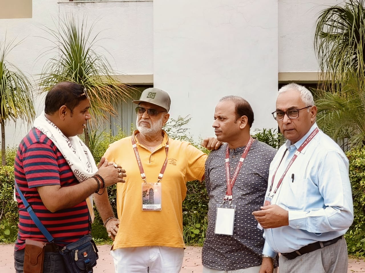 Delegates wearing conference lanyards talking outside the venue