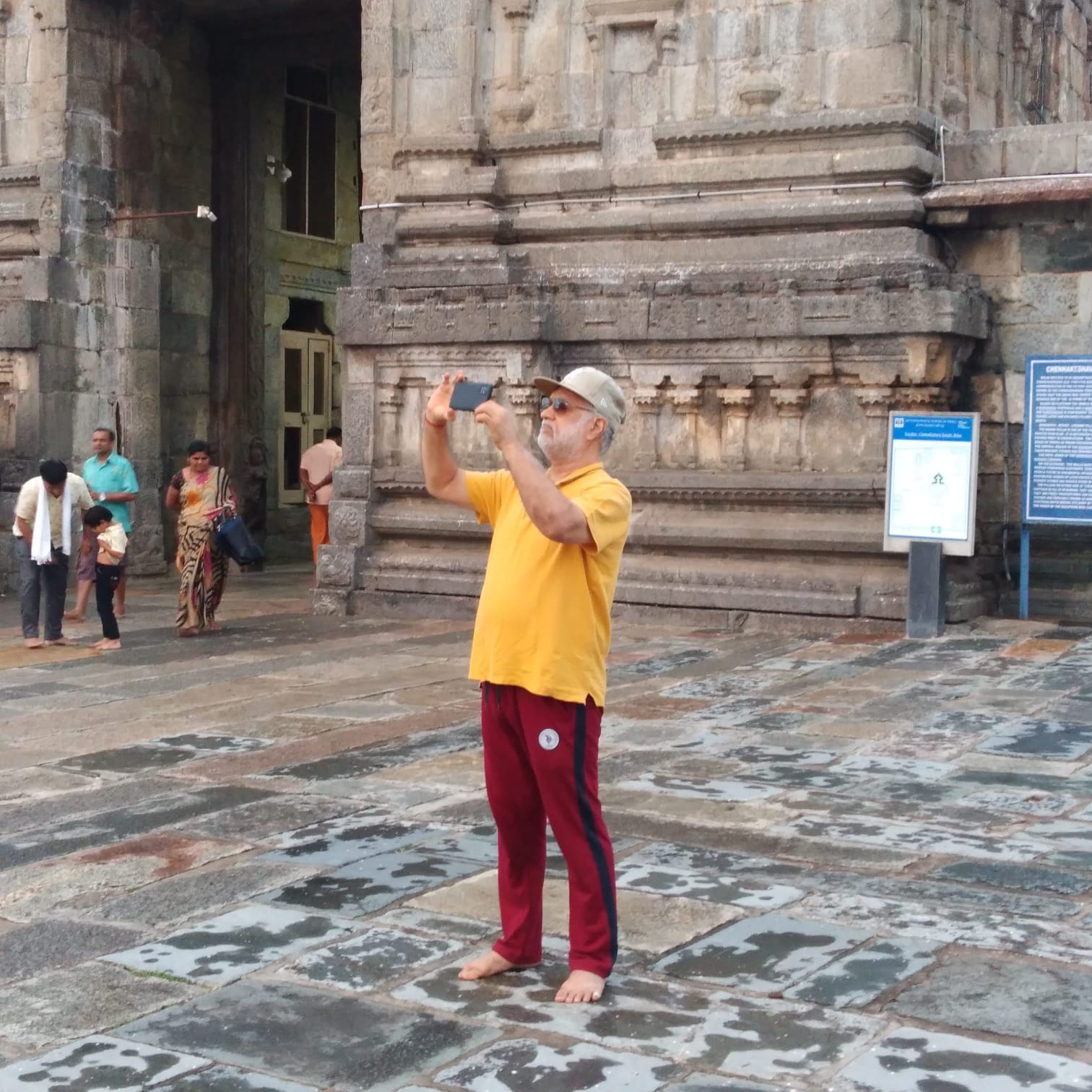 Vipin Bhardwaj photographing a temple gopuram in the courtyard