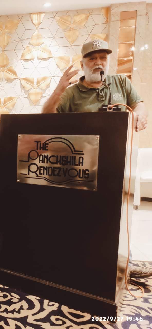 Vipin Bhardwaj addressing an audience from the podium at an evening function