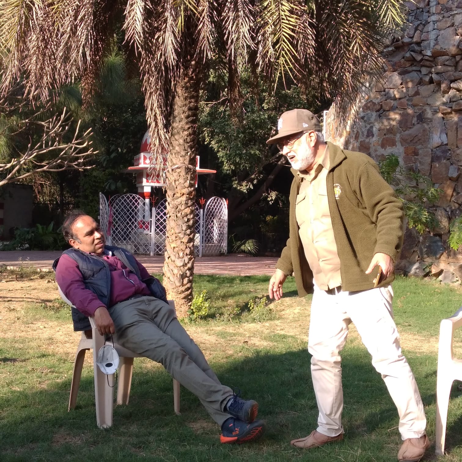 Vipin Bhardwaj speaking animatedly with a colleague on a winter afternoon