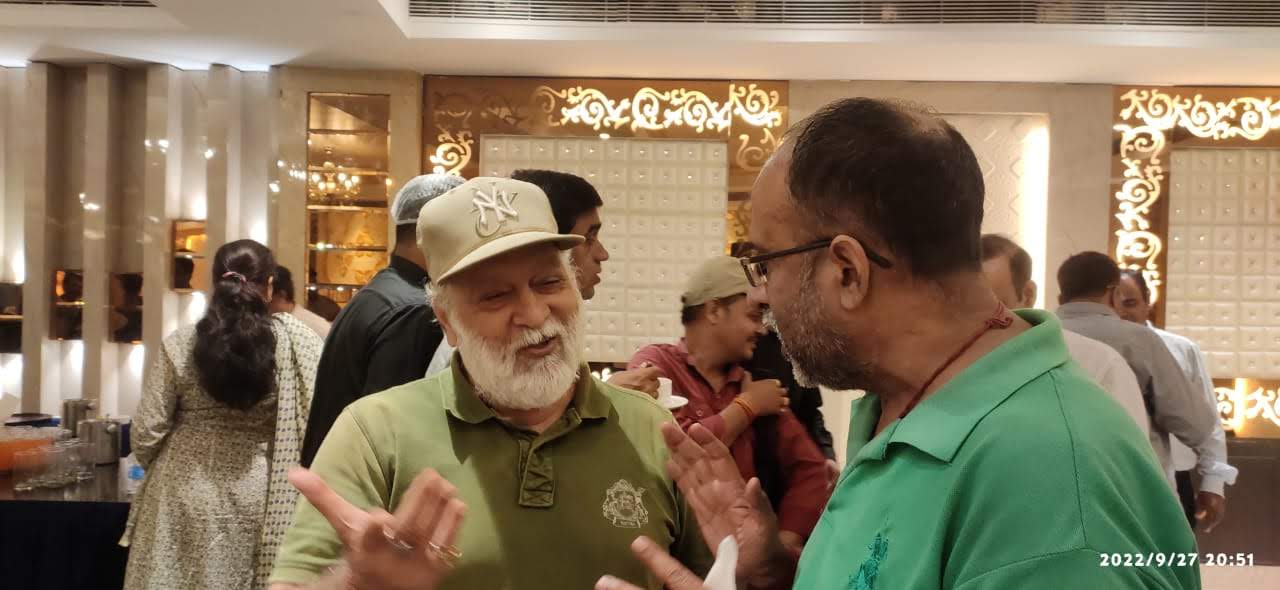 Vipin Bhardwaj in conversation with a colleague at an evening banquet